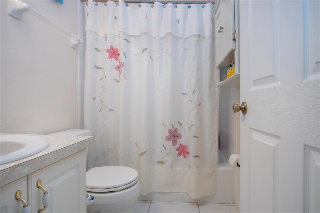 4010 North Lockwood Ridge Road Sarasota, FL 34235 - Photo 41 of 64 a white toilet sitting next to a bathroom sink