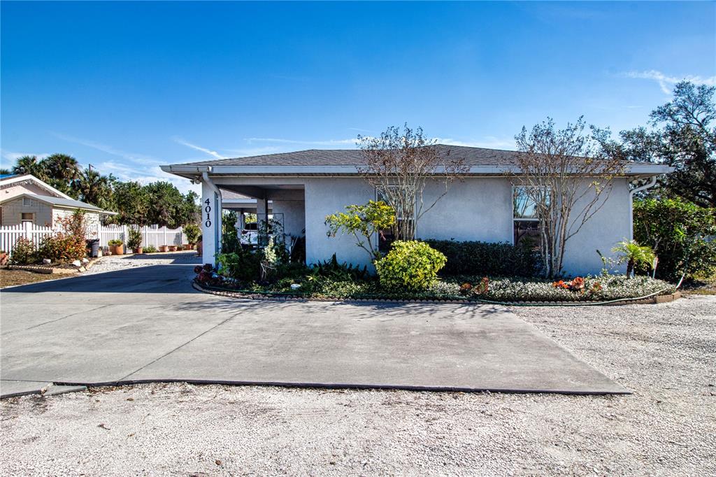 4010 North Lockwood Ridge Road Sarasota, FL 34235 - Photo 55 of 64 a front view of a house with a yard and a garage