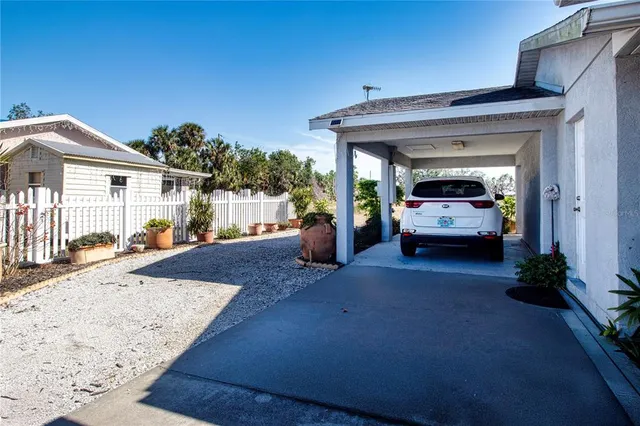 a living room with furniture a window and a potted plant