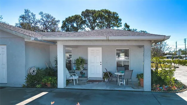 a kitchen with stainless steel appliances granite countertop a refrigerator a stove a sink dishwasher with a dining table and chairs with wooden floor