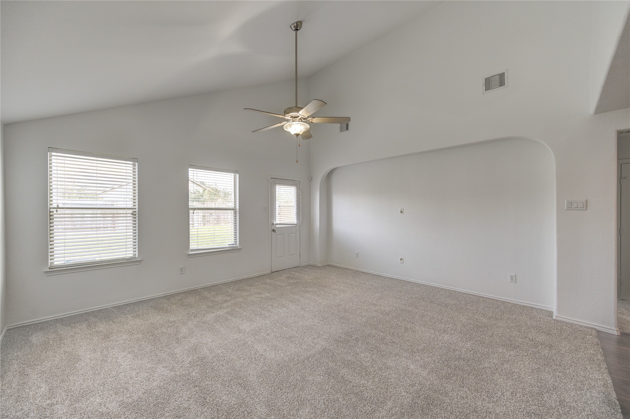 2010 Louetta Stream Way Spring, TX 77388 - Photo 13 of 47 an empty room with a chandelier fan and windows