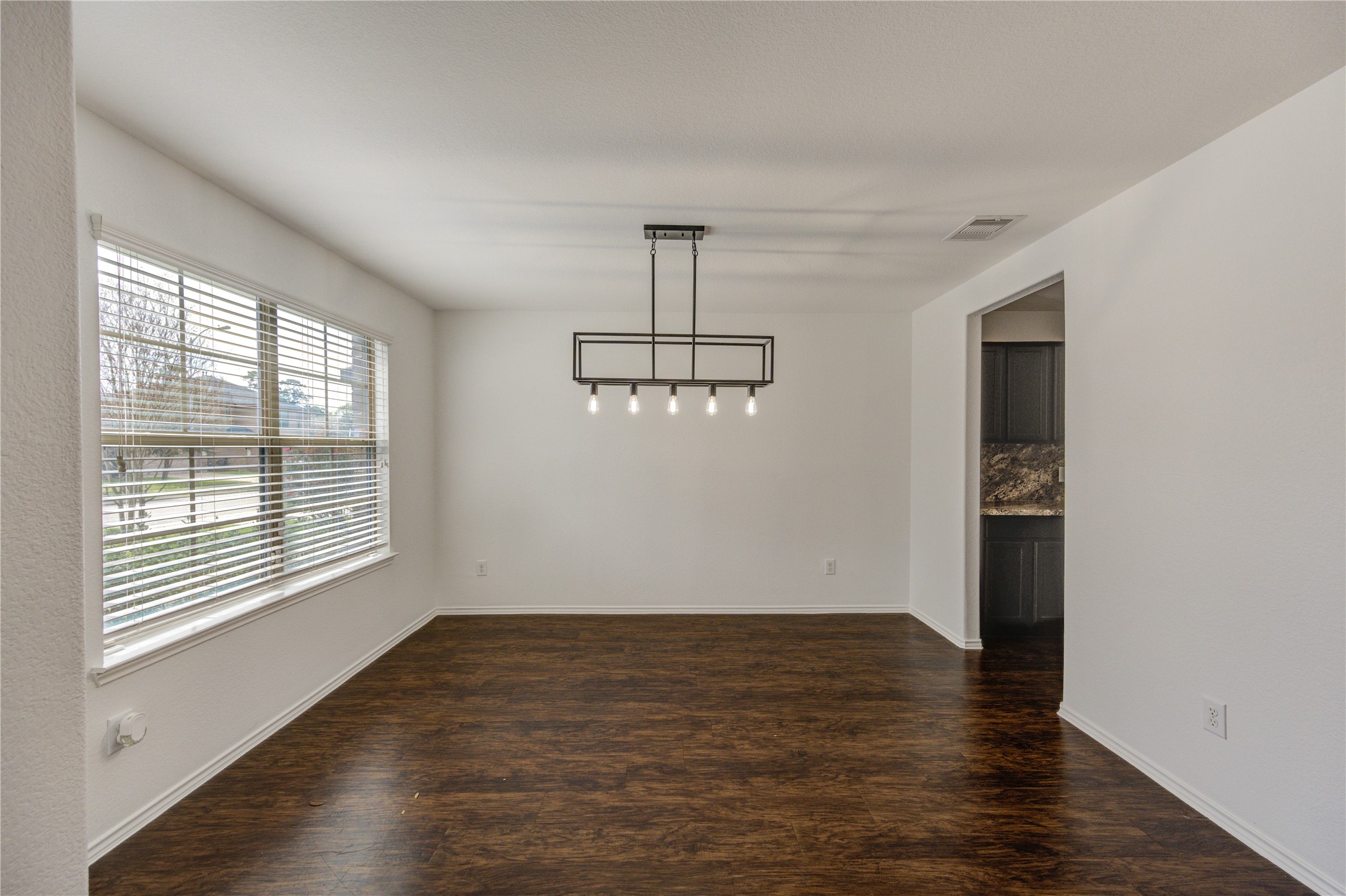 2010 Louetta Stream Way Spring, TX 77388 - Photo 2 of 47 a view of an empty room with wooden floor and a window