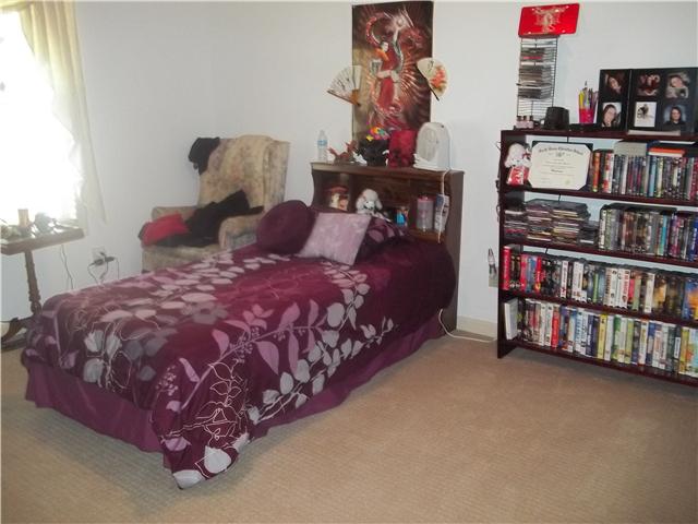 809 Hillside Drive Springfield, TN 37172 - Photo 5 of 16 a bedroom with a bed and a book shelf