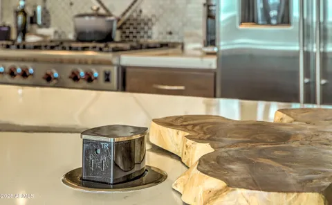 a kitchen with a sink a counter appliances and cabinets