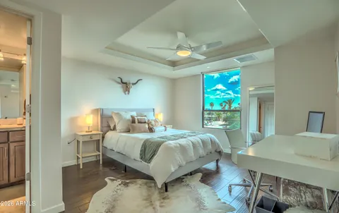 a bed sitting in a bedroom next to a window