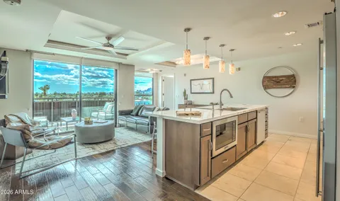 a kitchen with a sink stove and living room