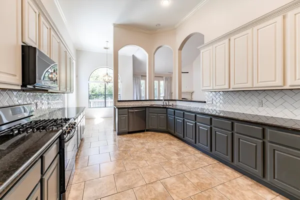 a kitchen with stainless steel appliances a sink stove and cabinets