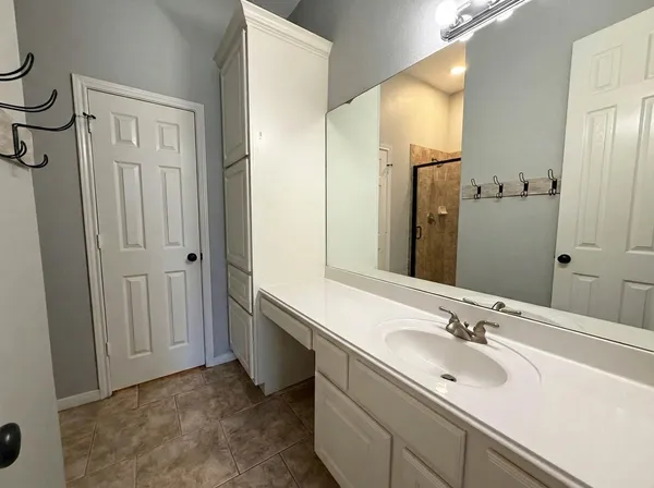 a view of a bathroom with a sink a toilet and a mirror