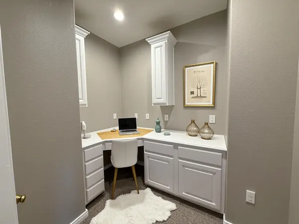 an empty room with windows and ceiling fan