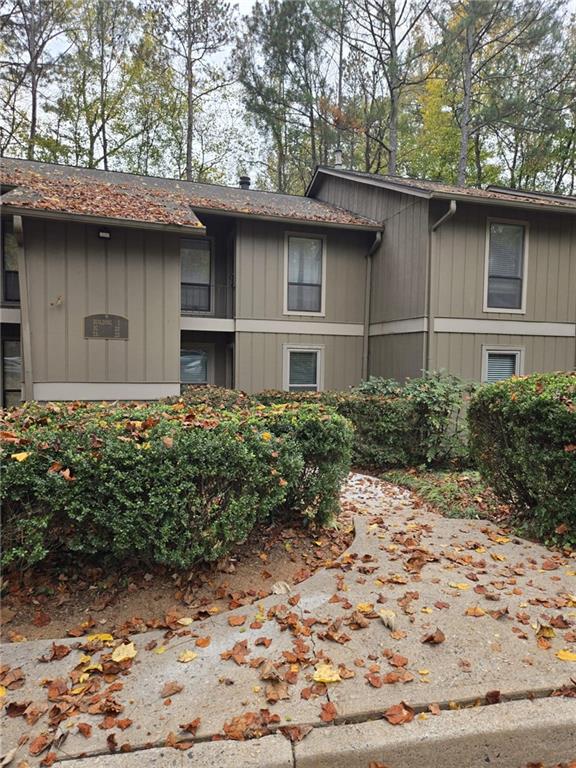 8740 Roswell Road, Unit 2B Atlanta, GA 30350 - Photo 2 of 12 a front view of a house with a garden