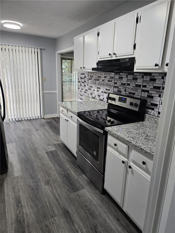 8740 Roswell Road, Unit 2B Atlanta, GA 30350 - Photo 4 of 12 a kitchen with granite countertop a stove and a sink