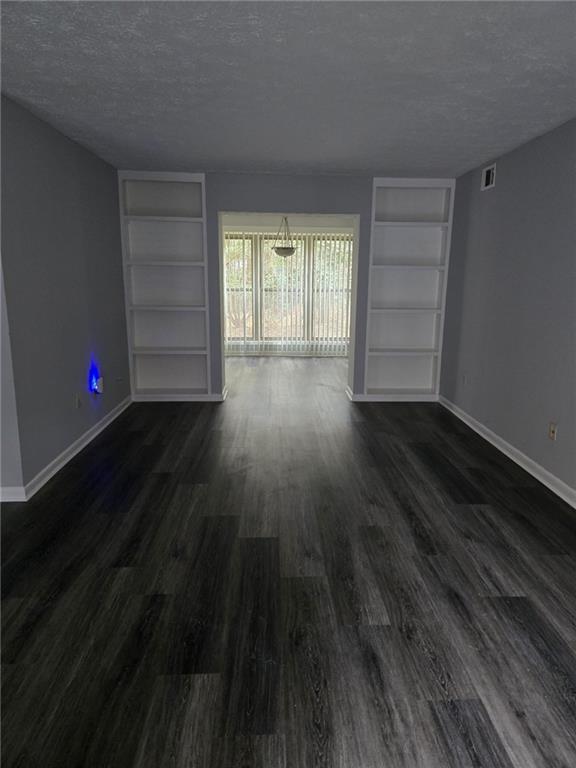 8740 Roswell Road, Unit 2B Atlanta, GA 30350 - Photo 6 of 12 wooden floor in an empty room with a window