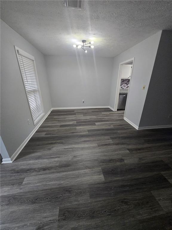 8740 Roswell Road, Unit 2B Atlanta, GA 30350 - Photo 7 of 12 a view of an empty room with wooden floor and a window
