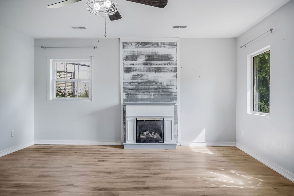 87 Camp Overton Road Rock Island, TN 38581 - Photo 11 of 46 a view of an empty room with wooden floor fireplace and a window