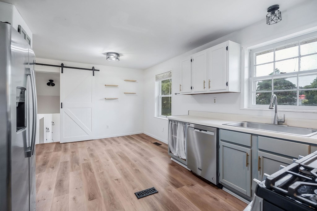 87 Camp Overton Road Rock Island, TN 38581 - Photo 16 of 46 a kitchen with wooden cabinets and a sink