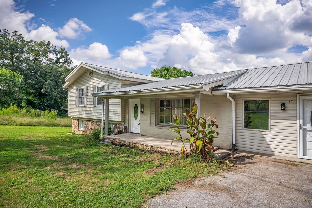 87 Camp Overton Road Rock Island, TN 38581 - Photo 4 of 46 a front view of a house with garden