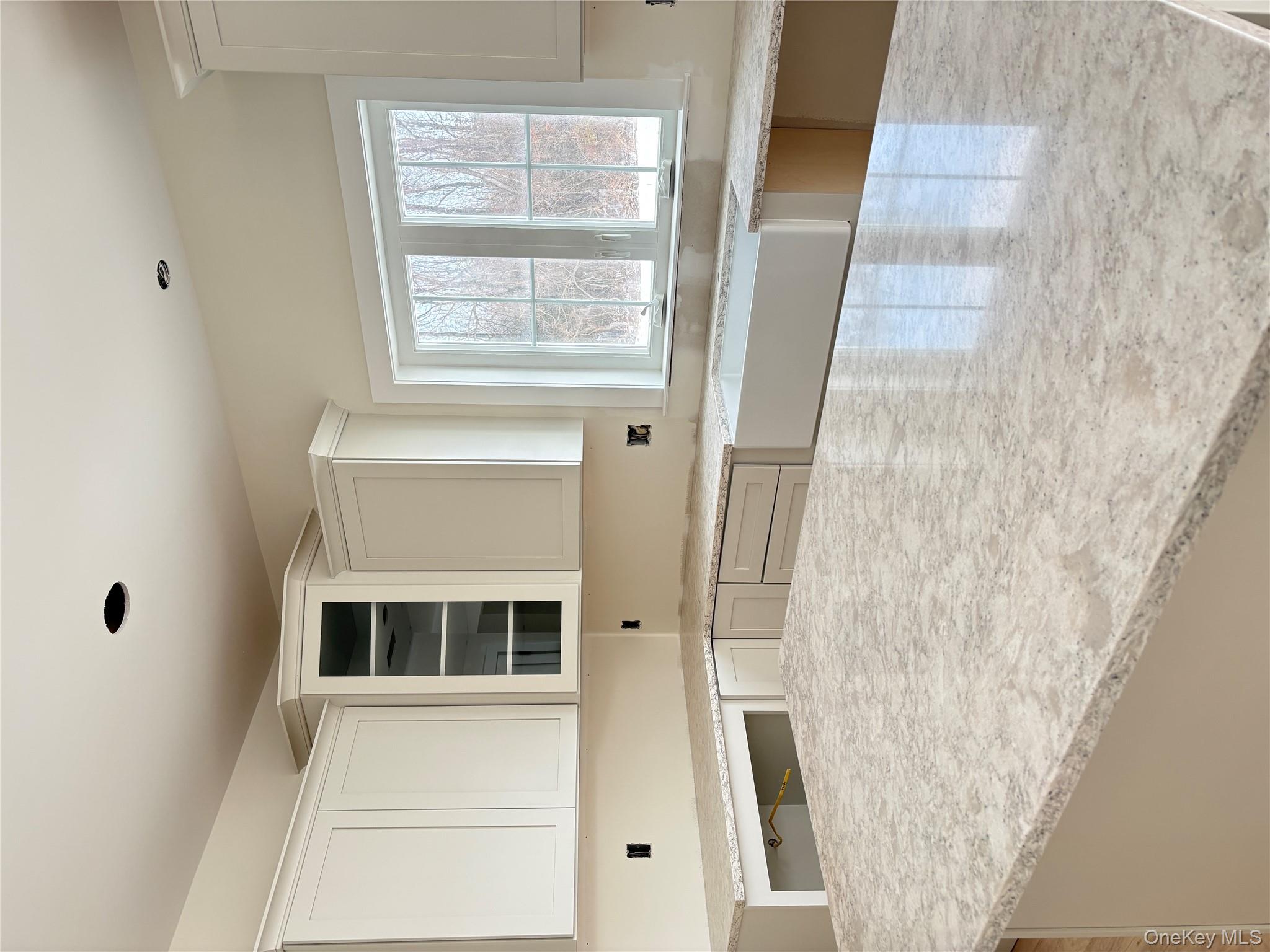 472 Wheeler Road Florida, NY 10921 - Photo 13 of 32 Kitchen with light stone countertops, white cabinetry, and glass insert cabinets