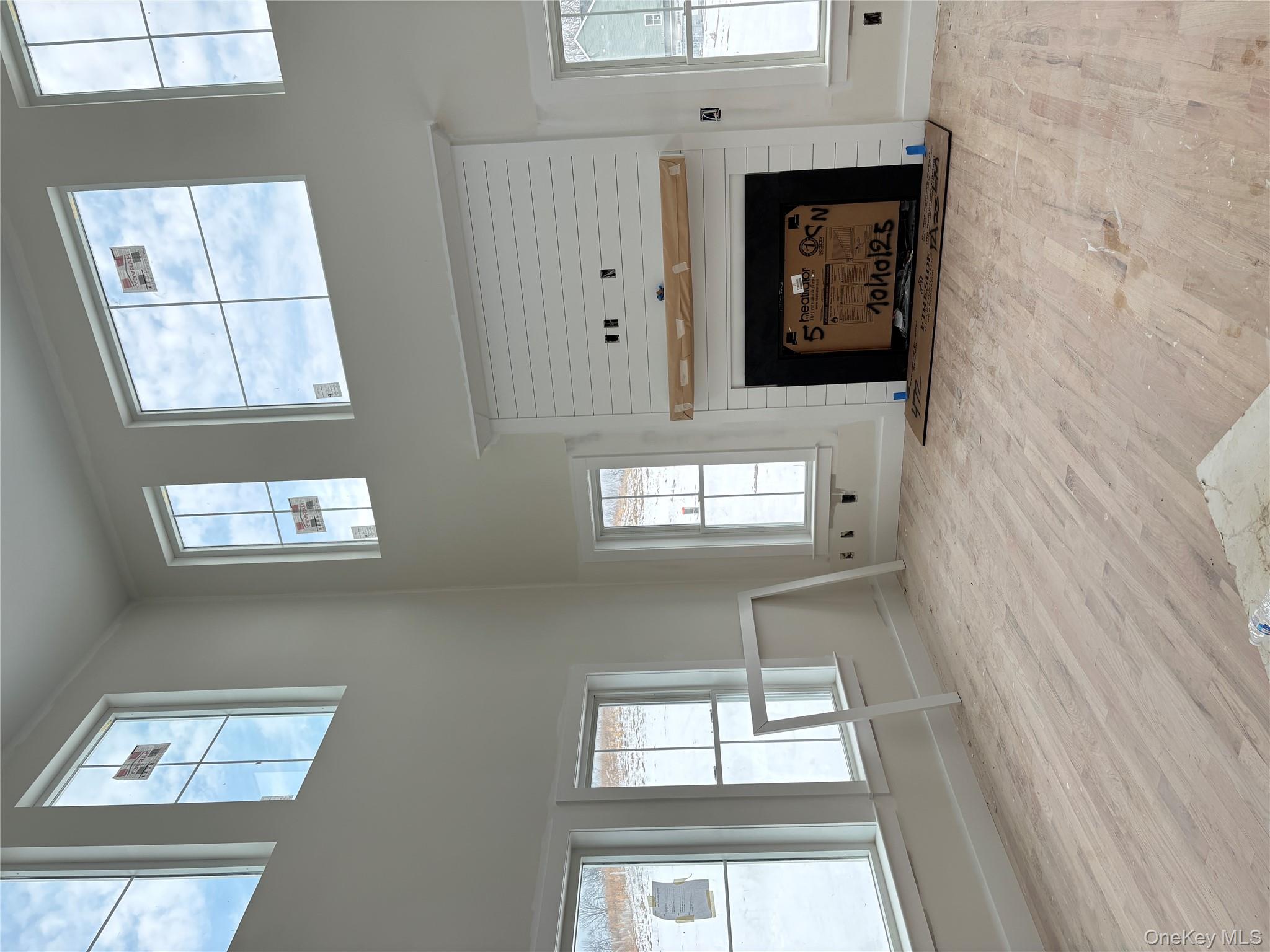 472 Wheeler Road Florida, NY 10921 - Photo 9 of 32 an empty room with windows and fireplace