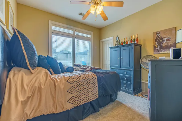 a bedroom with a bed dresser and a window