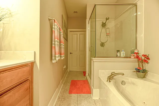 a bathroom with a tub sink and mirror