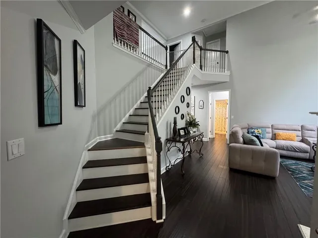 a view of entryway and hall with wooden floor