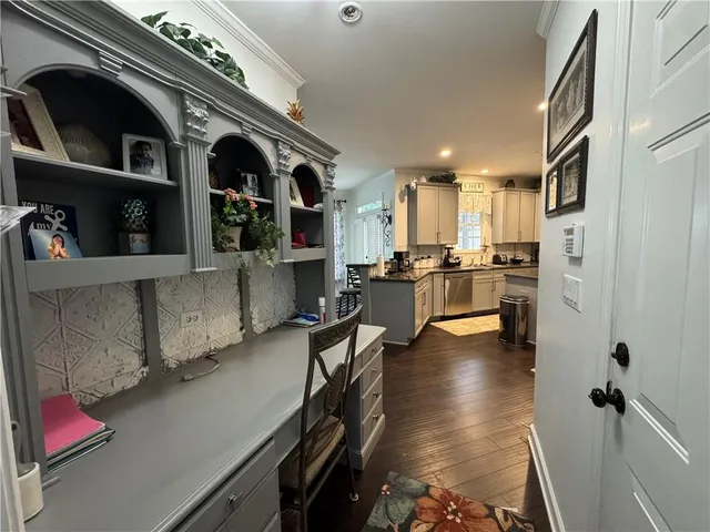 a kitchen with stainless steel appliances kitchen island granite countertop a refrigerator and a sink
