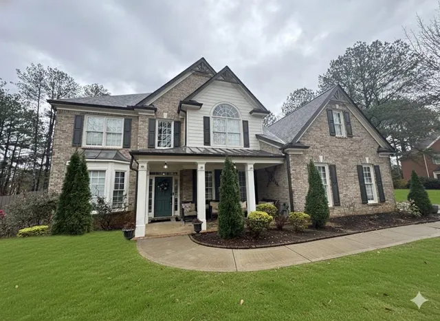 a front view of a house with a yard and porch