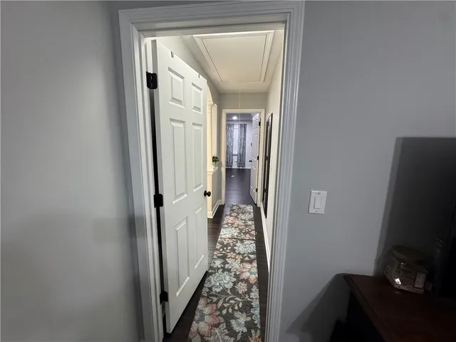 a view of hallway with mirror and window