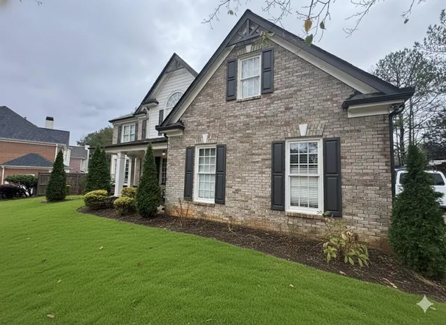 a front view of a house with a yard