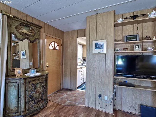 a kitchen with stainless steel appliances wooden floor and dining table