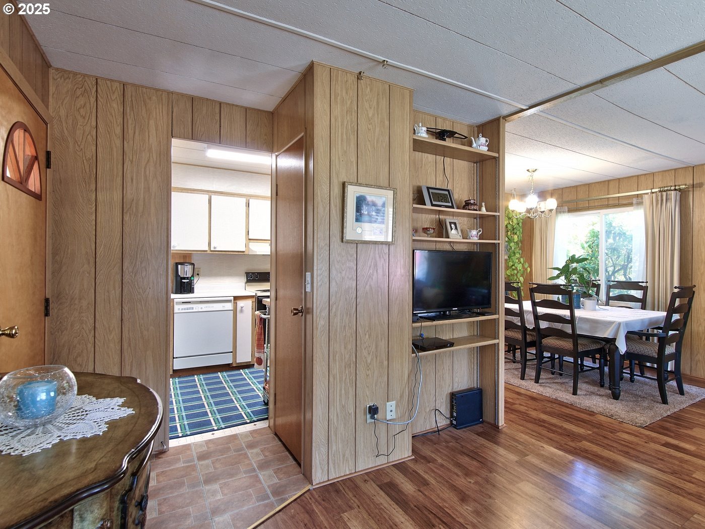 2681 Southeast River Road, Unit 44 Hillsboro, OR 97123 - Photo 20 of 47 a kitchen with stainless steel appliances wooden floor and dining table