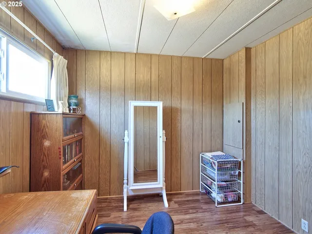 a view of a workspace with furniture and window