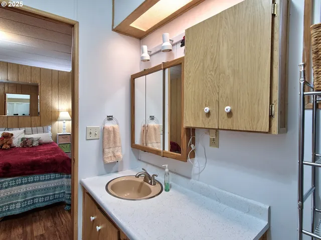 a bedroom with a bed and a mirror