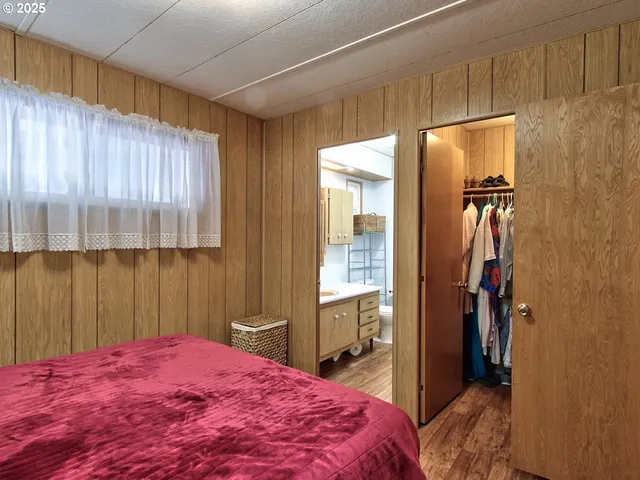 a bathroom with a sink a toilet a mirror and shower