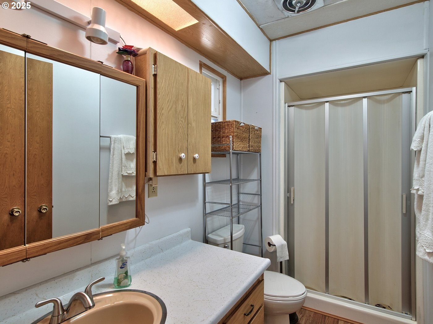 2681 Southeast River Road, Unit 44 Hillsboro, OR 97123 - Photo 40 of 47 a bathroom with a sink a toilet a mirror and shower