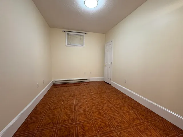 a view of a room with wooden floor and white walls