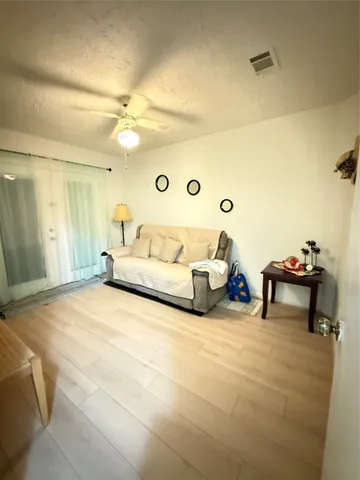 a spacious bedroom with a bed and a chandelier