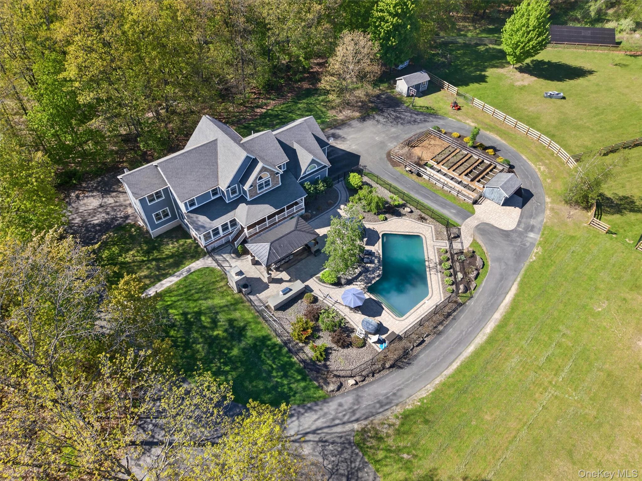 2 White Horse Road Middletown, NY 10940 - Photo 2 of 47 An aerial view highlighting the home’s expansive setting including beautiful pool and patio, mature gardens, outbuildings, and room to roam!