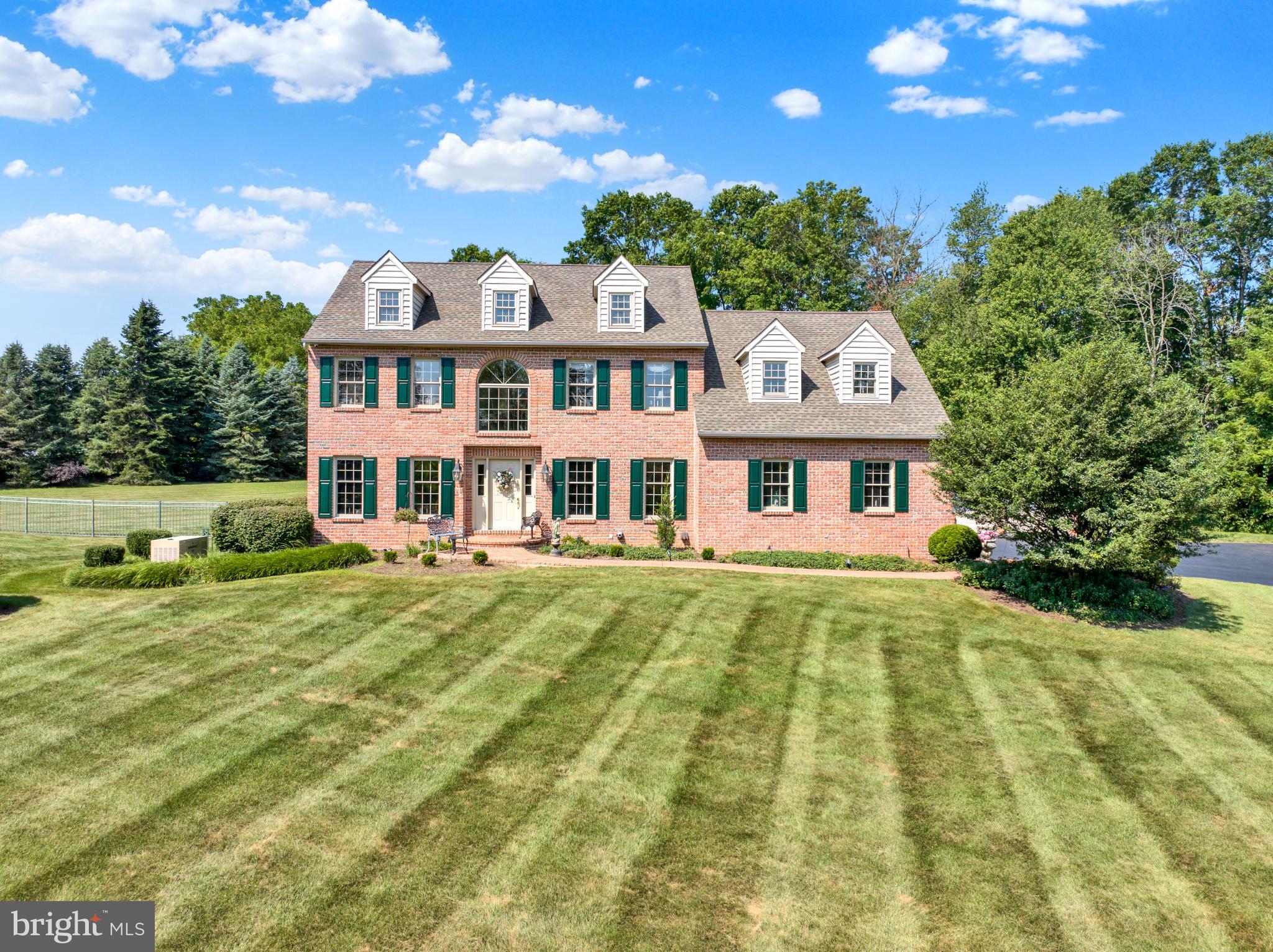 85 Bollinger Road Elverson, PA 19520 - Photo 3 of 87 Charming brick home with lush green surroundings.