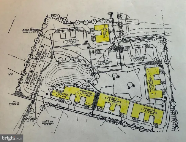 a view of a swimming pool with a bench and some potted plants