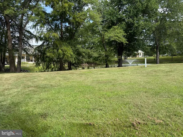 a swimming pool with trees in the background