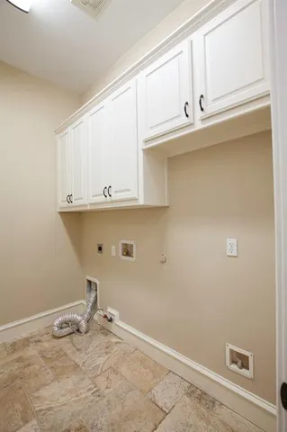 a view of a kitchen with white cabinets
