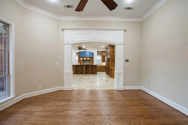 a view of a livingroom with wooden floor and a ceiling fan