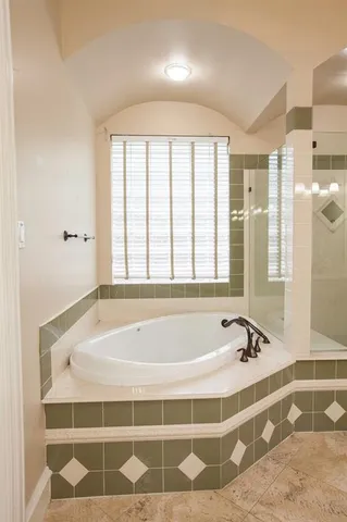 a spacious bathroom with a tub and shower