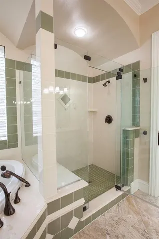 a bathroom with a shower and a sink