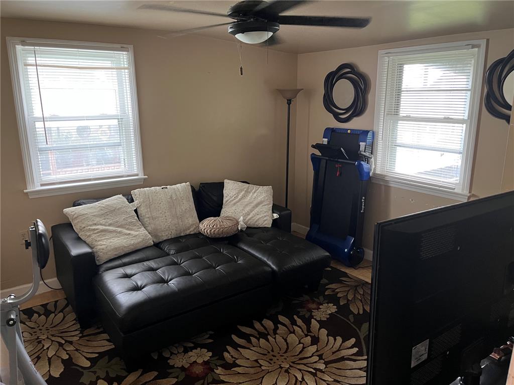 765 3rd Street Whitehall, PA 18052 - Photo 14 of 30 A versatile room featuring dual windows and ample space, perfect for relaxation or an exercise area.