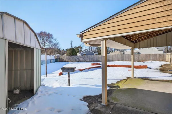 a view of a patio with a table and chairs