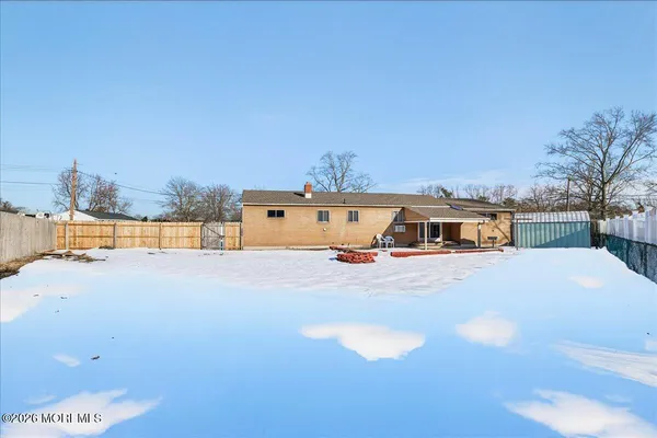 a view of a house with a yard and covered with snow