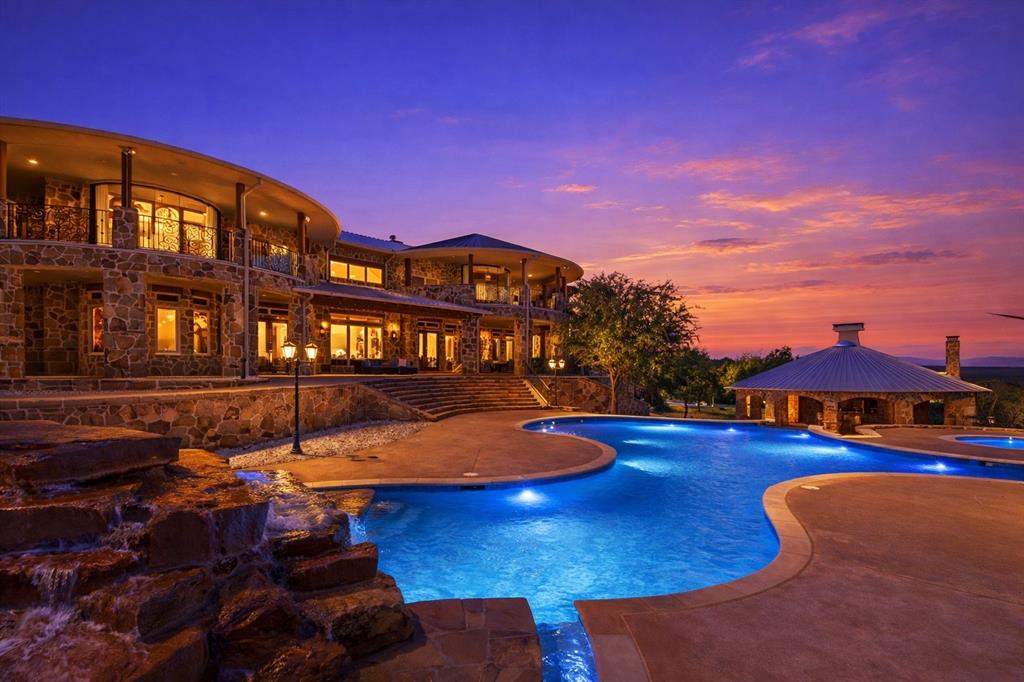 1180 McReynolds Road Sanger, TX 76266 - Photo 33 of 40 Expansive multi-level custom stone exterior residence with an integrated resort-style pool and rock waterfall feature