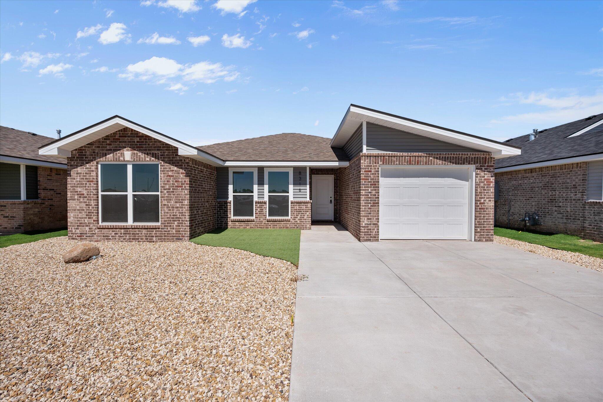 8316 24th Street Lubbock, TX 79407 - Photo 1 of 22 a front view of a house with a yard and garage